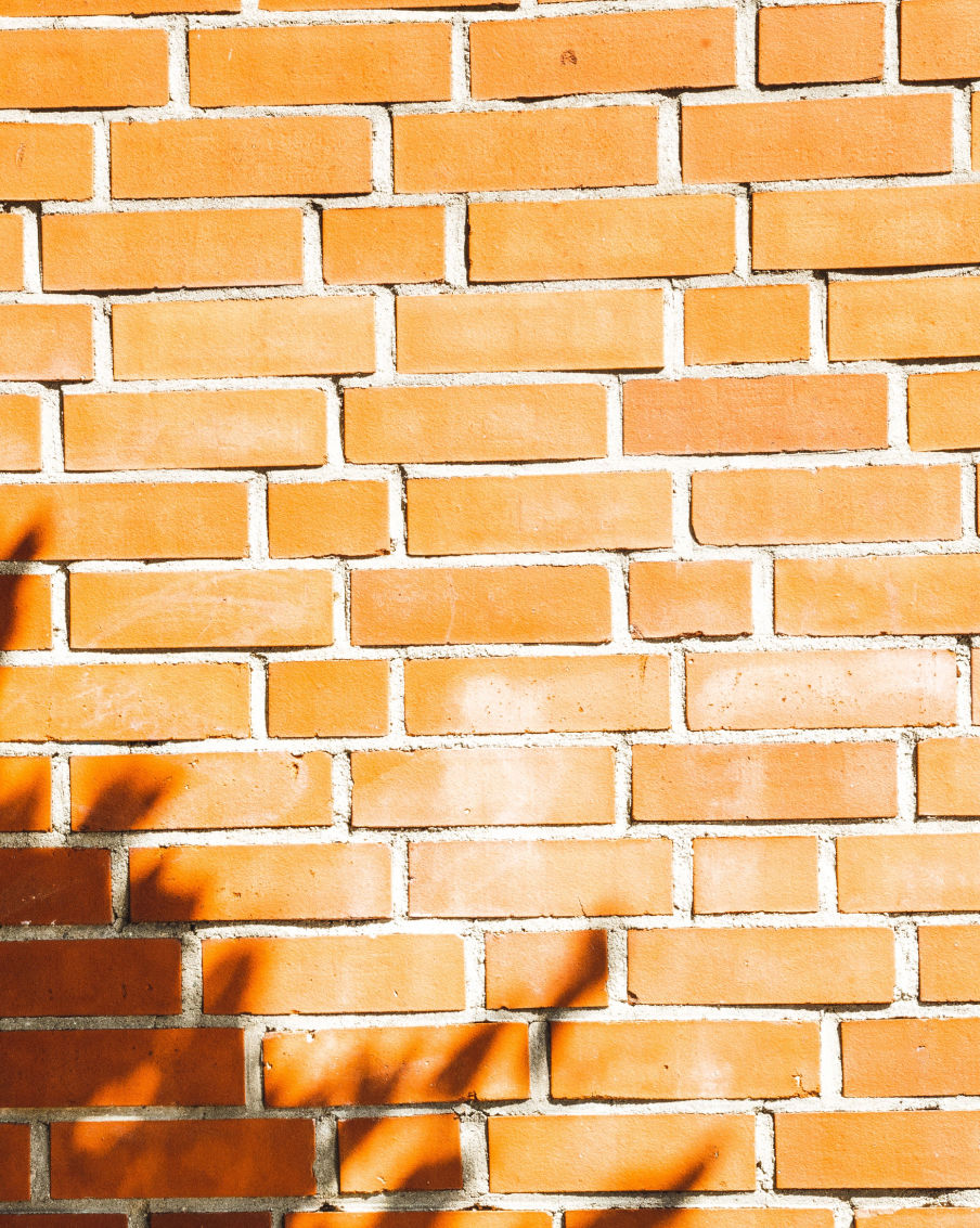 Vertical Shot Of The Red Brick Wall Under Sunlight 2023 11 27 05 13 21 Utc 1